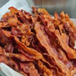 Want to know how to make crispy bacon that doesn’t curl and tastes even better? Discover the one surprising ingredient that guarantees perfect bacon every time!