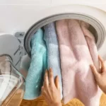 Clean white towels and clothes showing why you should never wash towels with clothing
